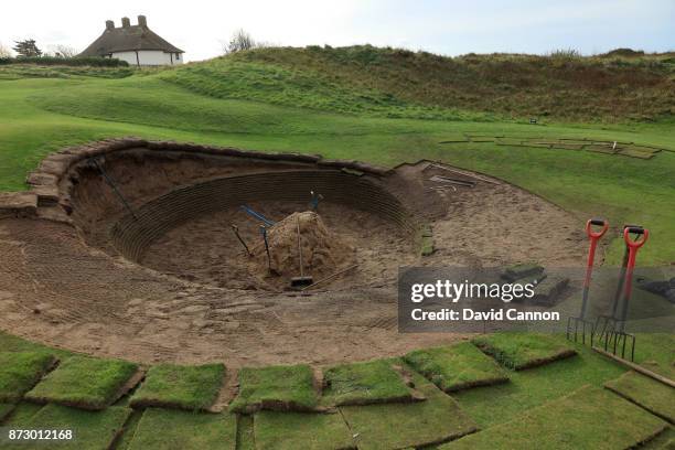 Maintenance work being carried out on the famous deep greenside bunker on the par 5, eighth hole which plays as the 10th hole in The Open...