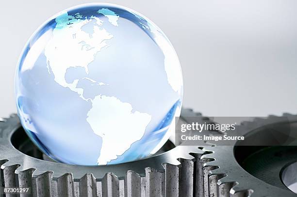 planet earth and machine cogs - planetary gear stock pictures, royalty-free photos & images