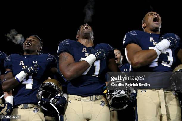 Evan Martin of the Navy Midshipmen and teammates celebrate after defeating Southern Methodist Mustangs, 43-40, at Navy-Marines Memorial Stadium on...
