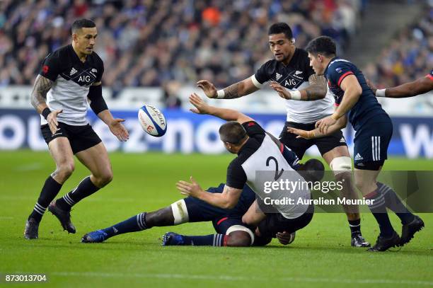 Dane Coles of New Zealand is tackled by Judicael Cancoriet of France during the test match between France and New Zealand at Stade de France on...