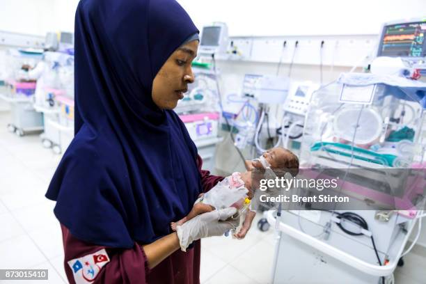 Nurses attend premature babies inside the new neo-natal unit at the Turkish built and run hospital in Mogadishu. The child in this image weighed only...