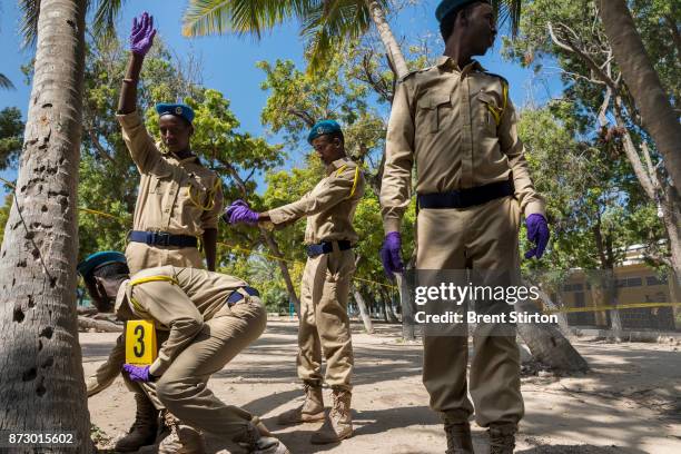 Police candidates attend a crime scene investigation class in Mogadishu. As well as classroom lessons, on this day they are also seen conducting a...