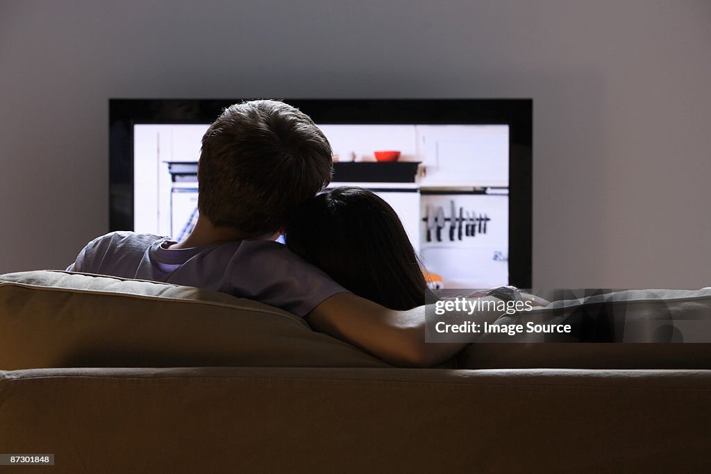 Rear view of a couple watching tv