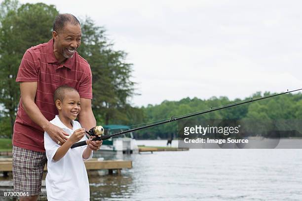 a grandfather teaching his grandson to fish - 9 loch stock pictures, royalty-free photos & images