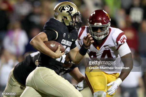 Quarterback Steven Montez of the Colorado Buffaloes caries the ball against the USC Trojans at Folsom Field on November 11, 2017 in Boulder, Colorado.
