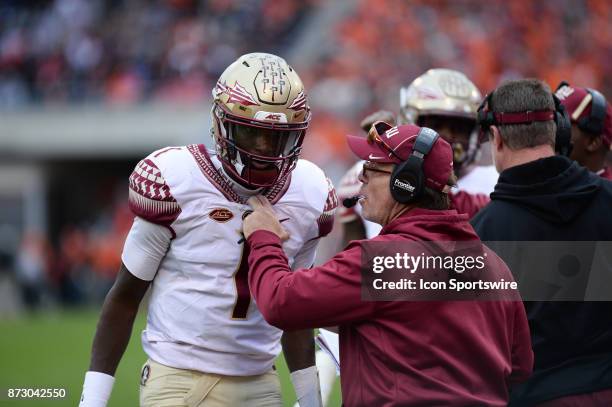 Florida State quarterback James Blackman talks with head coach Jimbo Fisher during 1st half action between the Clemson Tigers and the Florida State...