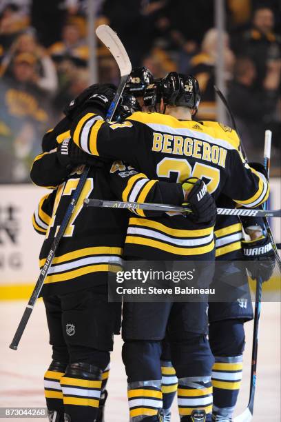 Patrice Bergeron of the Boston Bruins and his line mates celebrate a first period goal against the Toronto Maple Leafs at the TD Garden on November...