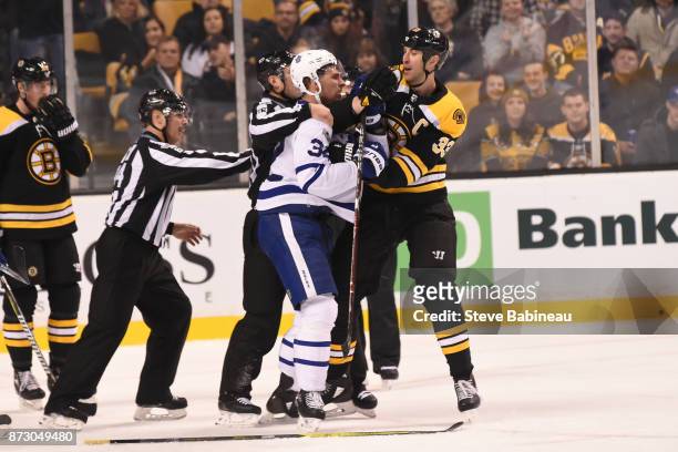 Auston Matthews of the Toronto Maple Leafs gets physical with Zdeno Chara of the Boston Bruins at the TD Garden on November 11, 2017 in Boston,...