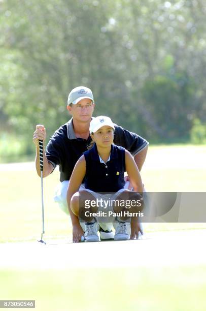 Year old Cheyenne Woods niece of Golfer Tiger Woods with her coach Kent Chase takes part in a junior golf tournament at The Singing Hills Resort on...