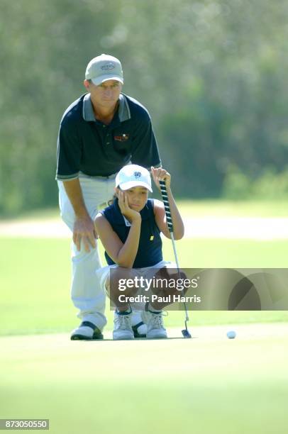 Year old Cheyenne Woods niece of Golfer Tiger Woods with her coach Kent Chase takes part in a junior golf tournament at The Singing Hills Resort on...