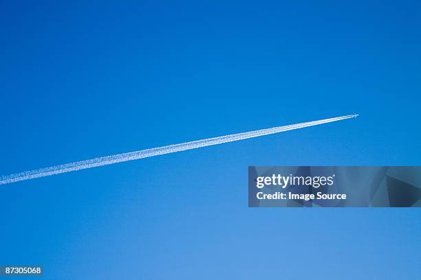 airplane and vapour trail - vapour trail stock pictures, royalty-free photos & images