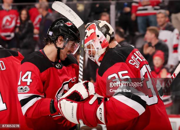 Adam Henrique and Cory Schneider of the New Jersey Devils celebrate the 2-1 win over the Florida Panthers on November 11, 2017 at Prudential Center...
