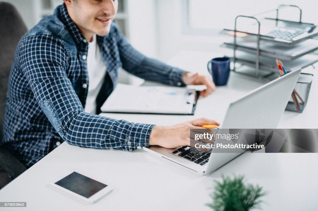 Business Person reading Data on paper Charts and Computer