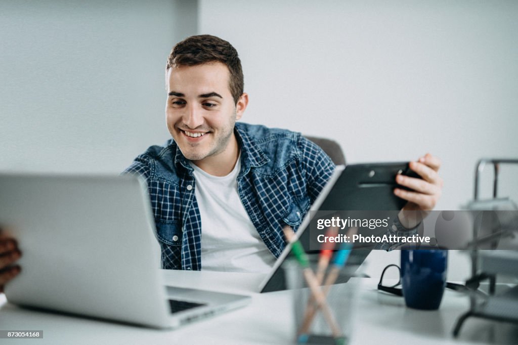 Business Person reading Data on paper Charts and Computer
