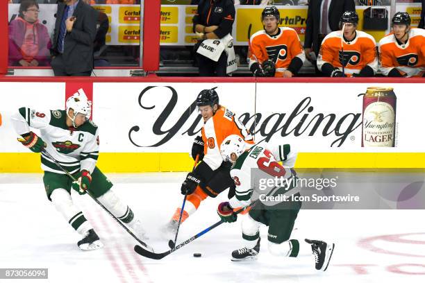 Philadelphia Flyers defenseman Robert Hagg steals the puck from Minnesota Wild left wing Tyler Ennis during the NHL game between the Minnesota Wild...