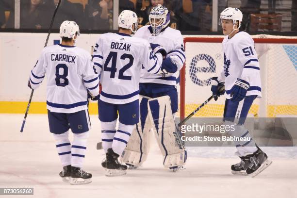 Connor Carrick, Tyler Bozak, Curtis McElhinney and Jake Gardiner of the Toronto Maple Leafs celebrate a win against the Boston Bruins at the TD...