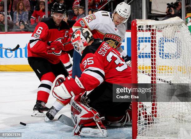 Cory Schneider of the New Jersey Devils stops a shot by Jonathan Huberdeau of the Florida Panthers in the third period on November 11, 2017 at...