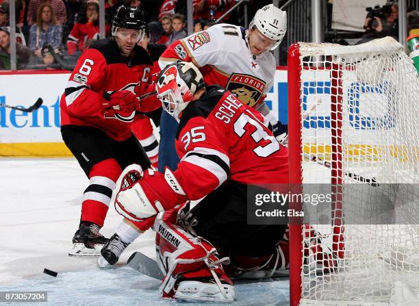 Cory Schneider of the New Jersey Devils stops a shot by Jonathan Huberdeau of the Florida Panthers in the third period on November 11, 2017 at...