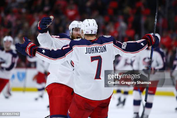 Jack Johnson of the Columbus Blue Jackets celebrates his shootout winning goal with teammates while playing the Detroit Red Wings at Little Caesars...