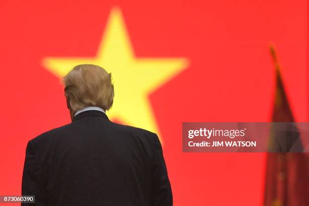 President Donald Trump inspects a guard of honour during a welcoming ceremony at the Presidential Palace in Hanoi on November 12, 2017. - Trump...