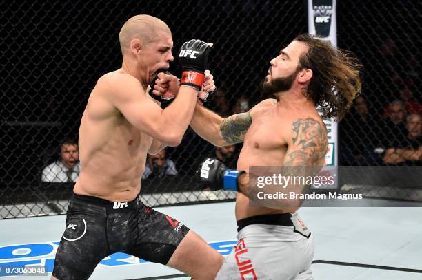 Clay Guida punches Joe Lauzon in their lightweight bout during the UFC Fight Night event inside the Ted Constant Convention Center on November 11,...
