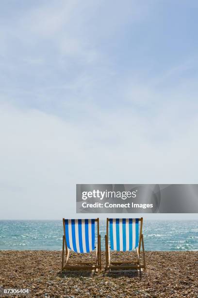 deckchairs on brighton beach - deckchair stock pictures, royalty-free photos & images