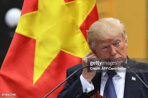 President Donald Trump attends a joint press conference with Vietnamese counterpart Tran Dai Quang at the Presidential Palace in Hanoi on November...