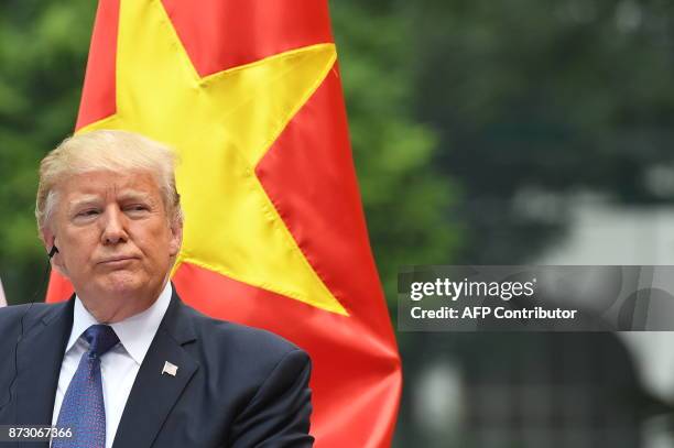 President Donald Trump attends a joint press conference with his Vietnamese counterpart Tran Dai Quang at the Presidential Palace in Hanoi on...