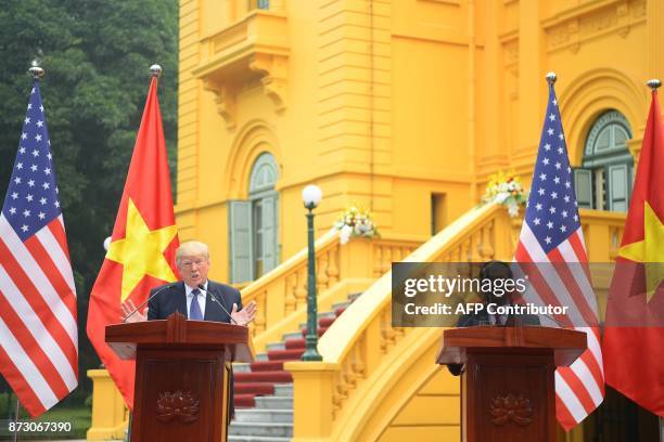 President Donald Trump attends a joint press conference with his Vietnamese counterpart Tran Dai Quang at the Presidential Palace in Hanoi on...