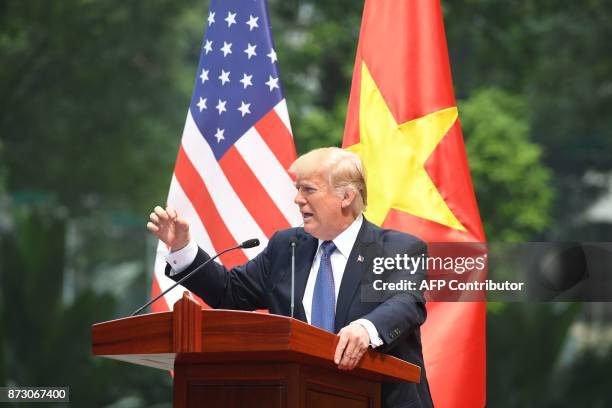 President Donald Trump attends a joint press conference with Vietnamese counterpart Tran Dai Quang at the Presidential Palace in Hanoi on November...