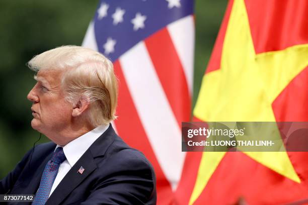 President Donald Trump attends a joint press conference with his Vietnamese counterpart Tran Dai Quang at the Presidential Palace in Hanoi on...