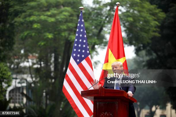 President Donald Trump attends a joint press conference with his Vietnamese counterpart Tran Dai Quang at the Presidential Palace in Hanoi on...