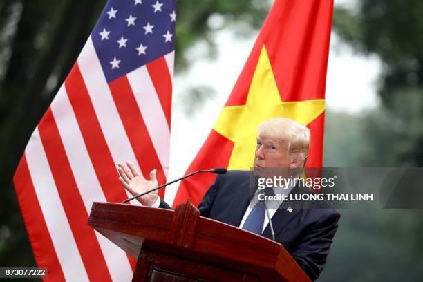 President Donald Trump attends a joint press conference with his Vietnamese counterpart Tran Dai Quang at the Presidential Palace in Hanoi on...