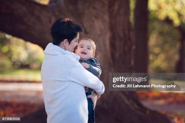 15 month old fraternal twin explores one yellow leaf on an autumn day - european best pictures of the day october 15 2017 stock-fotos und bilder