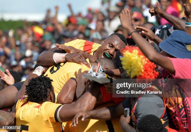Lachlan Lam of Papua New Guinea is congratulated by team mates after scoring a try during the 2017 Rugby League World Cup match between Papua New...