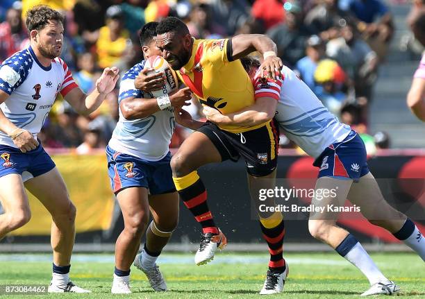 Moses Meninga of Papua New Guinea takes on the defence during the 2017 Rugby League World Cup match between Papua New Guinea and the United States on...