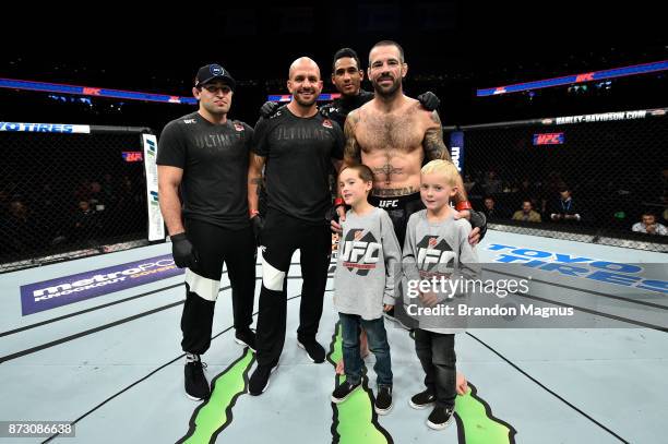 Matt Brown celebrates with his teammates and children after defeating Diego Sanchez in their welterweight bout during the UFC Fight Night event...