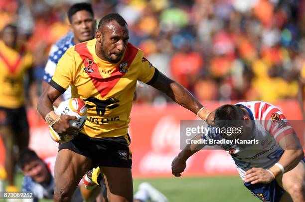 Stargroth Amean of Papua New Guinea breaks away from the defence during the 2017 Rugby League World Cup match between Papua New Guinea and the United...