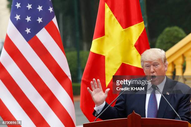 President Donald Trump speaks during a news conference at the Presidential Palace in Hanoi on November 12, 2017. - Trump told his Vietnamese...