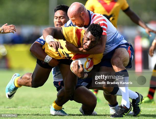 Moses Meninga of Papua New Guinea takes on the defence during the 2017 Rugby League World Cup match between Papua New Guinea and the United States on...