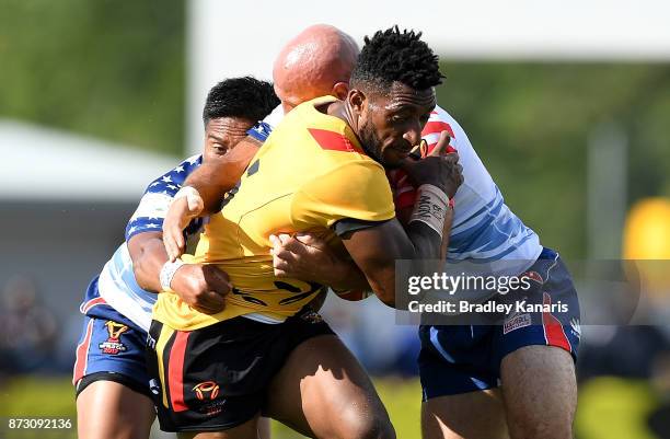 Moses Meninga of Papua New Guinea takes on the defence during the 2017 Rugby League World Cup match between Papua New Guinea and the United States on...