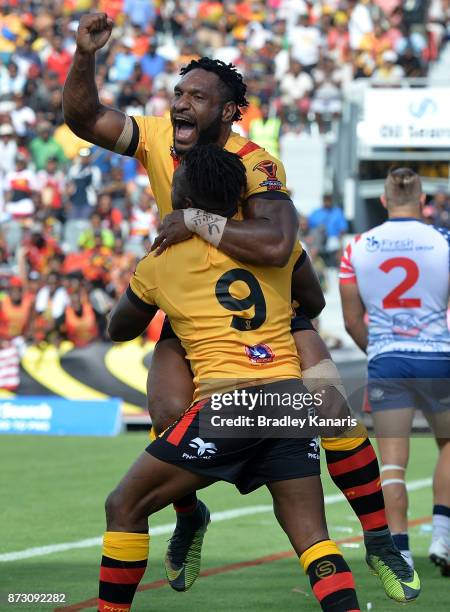 James Segeyaro of Papua New Guinea celebrates with team mate Garry Lo during the 2017 Rugby League World Cup match between Papua New Guinea and the...