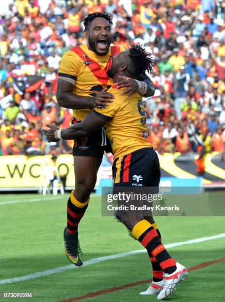 James Segeyaro of Papua New Guinea celebrates with team mate Garry Lo during the 2017 Rugby League World Cup match between Papua New Guinea and the...