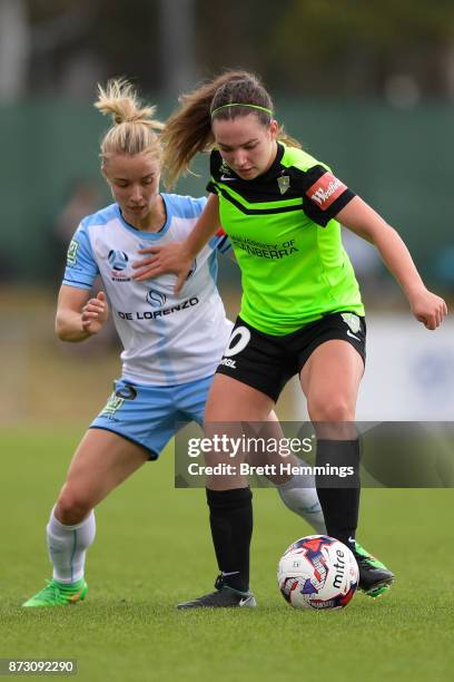 Grace Maher of Canberra is tackled by Georgia Yeoman-Dale of Sydney during the round three W-League match between Canberra United and Sydney FC at...