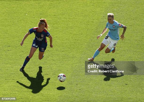 Tori Huster of the Jets is chased by Jess Fishlock of Melbourne City during the round three W-League match between Melbourne City and the Newcastle...