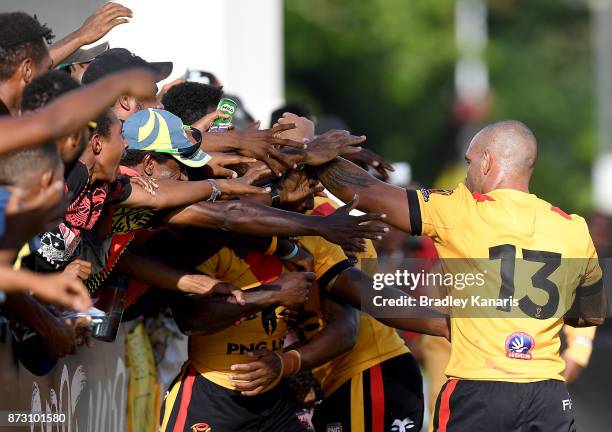 Watson Boas of Papua New Guinea is embraced by fans after scoring a try during the 2017 Rugby League World Cup match between Papua New Guinea and the...