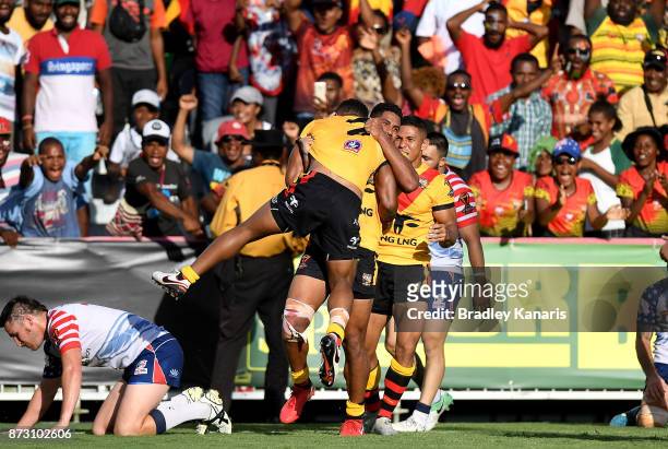 Justin Olam of Papua New Guinea celebrates with team mate Nene McDonald after scoring a try during the 2017 Rugby League World Cup match between...