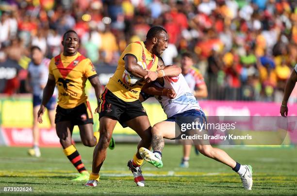 Stargroth Amean of Papua New Guinea takes on the defence during the 2017 Rugby League World Cup match between Papua New Guinea and the United States...