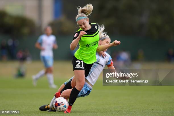 Ellie Carpenter of Canberra is tackled by Caitlin Cooper of Sydney during the round three W-League match between Canberra United and Sydney FC at...