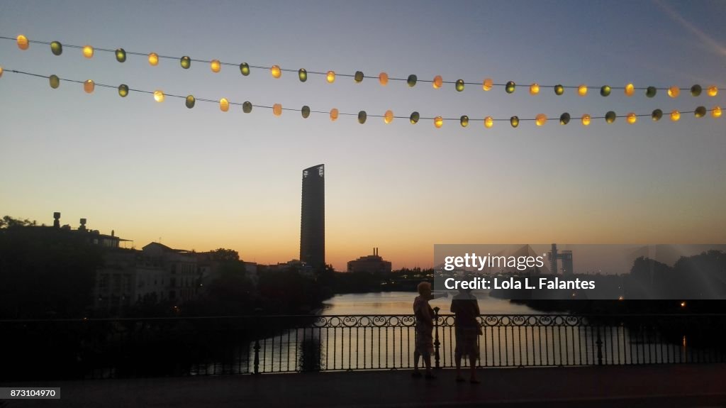 Crossing Triana bridge at sunset. Seville